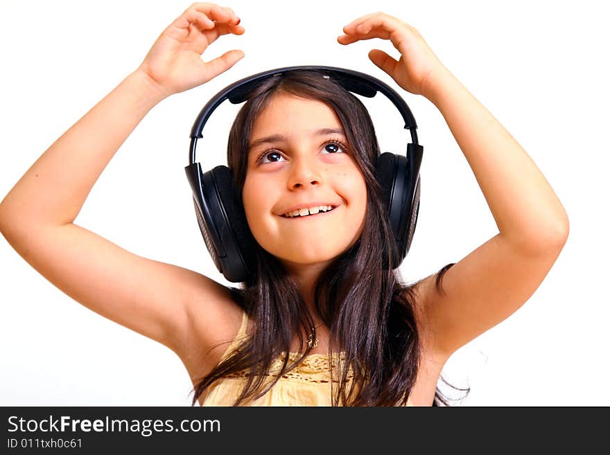 8 year old girl listening to music in big headphones. 8 year old girl listening to music in big headphones