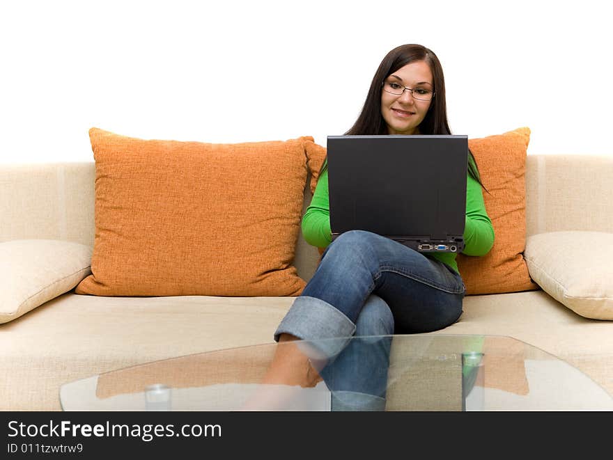 Attractive brunette woman sitting on sofa with laptop. Attractive brunette woman sitting on sofa with laptop