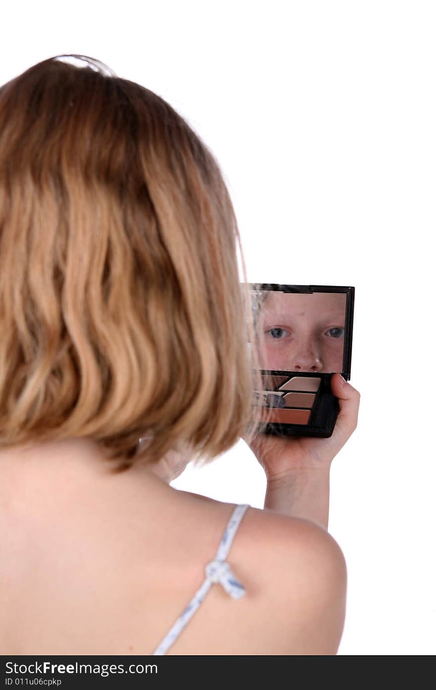 Young girl looking into mirror