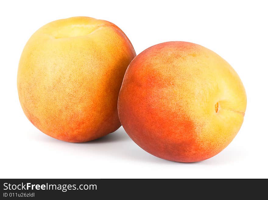 Two peaches on a white background. Isolated.