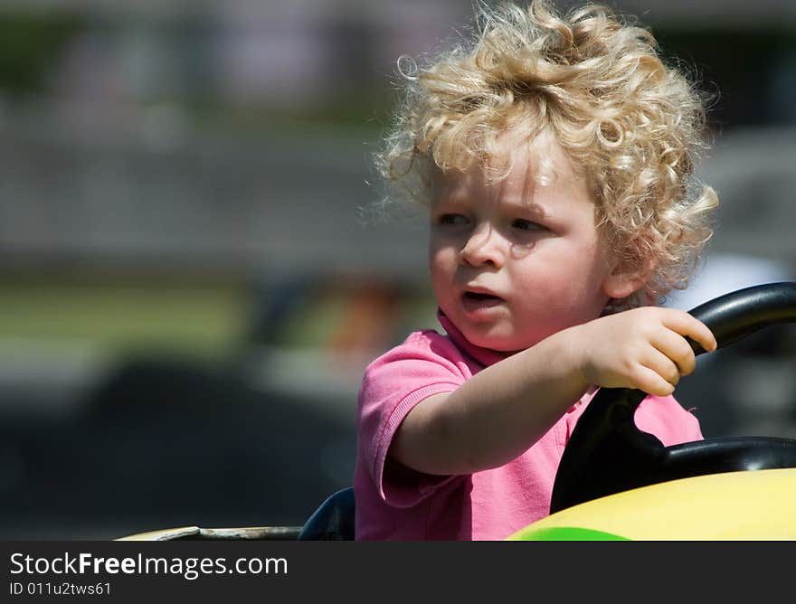 Cute young boy having fun in yellow car. Cute young boy having fun in yellow car