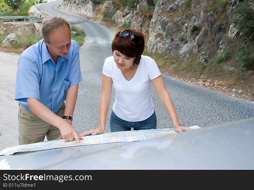 Family travels and look a map