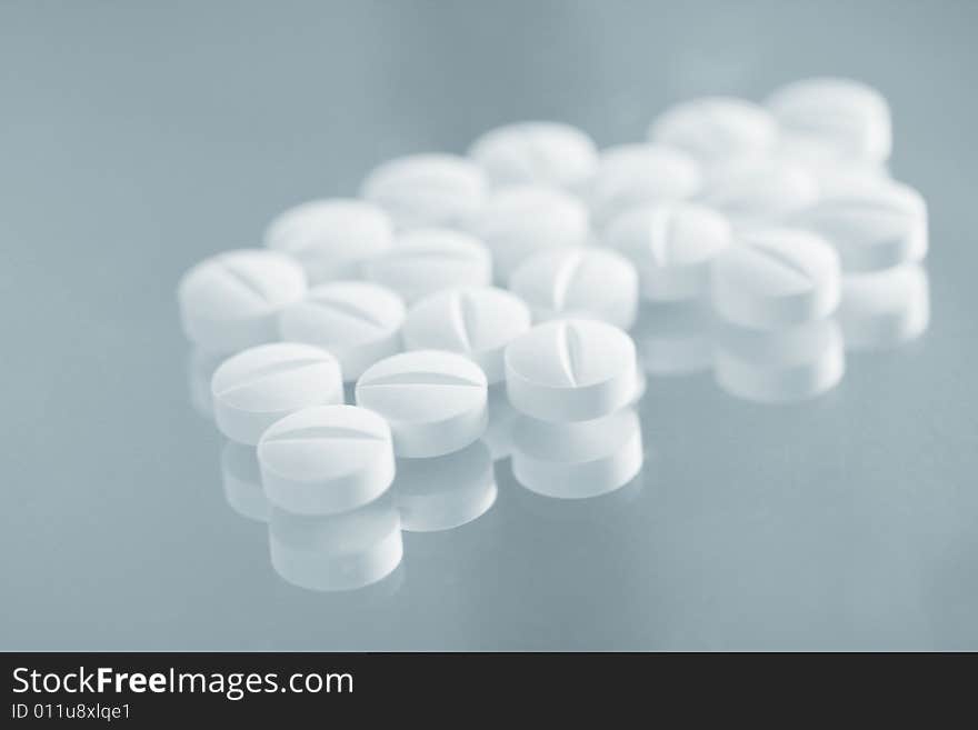 A few of pills on a blue background. A few of pills on a blue background