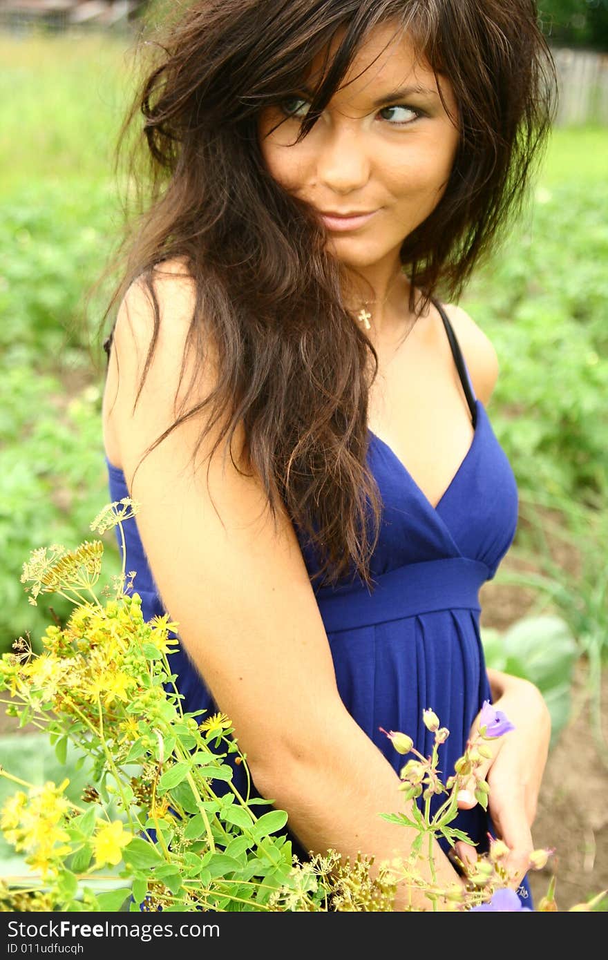 A girl with flowers in a blue dress