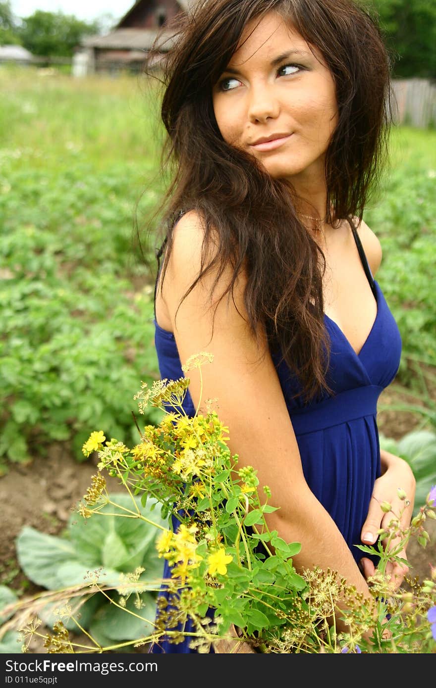 A girl with flowers in a blue dress