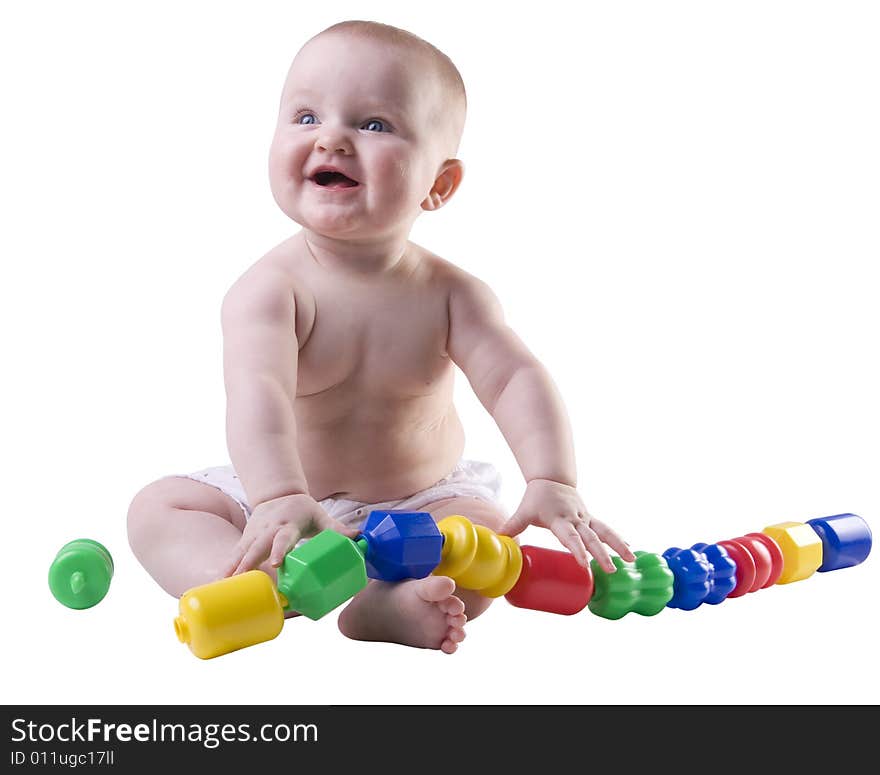 Baby holding large plastic beads in lap with smile on face. Baby holding large plastic beads in lap with smile on face.