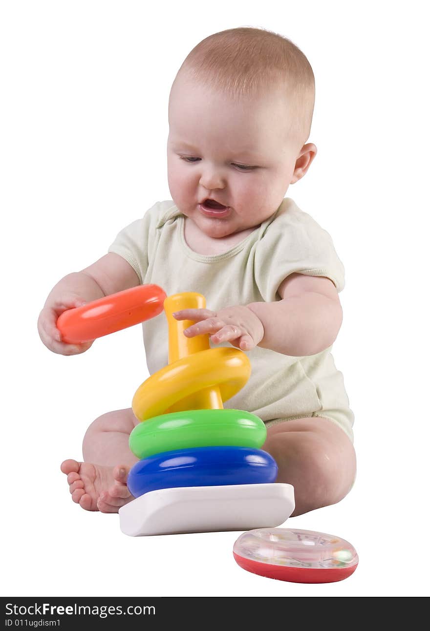 Baby girl puting ring on toy.