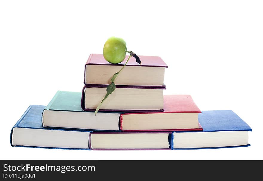 Apple on stack of books isolated on white background