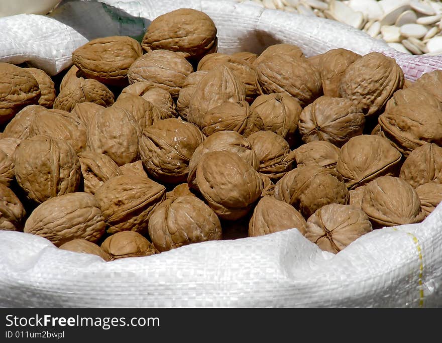 A bag of walnuts for sale at the market.