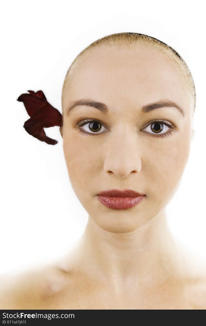 Woman with flower in hair; white background. Woman with flower in hair; white background