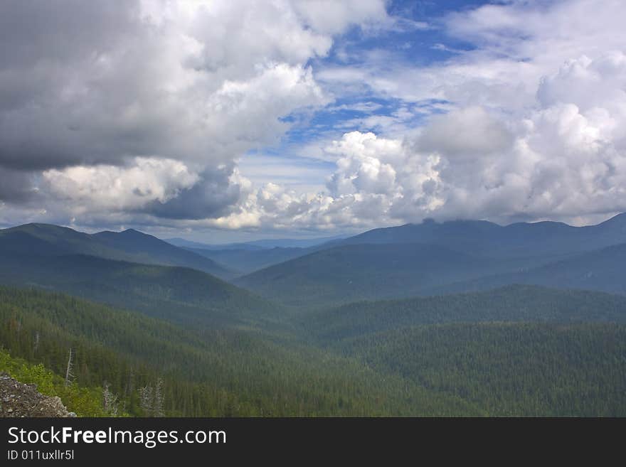 Mountains eyes of a bird. The fine sky and the infinite mountains disappearing in a blue fog. Beauty untouched the person of a nature.