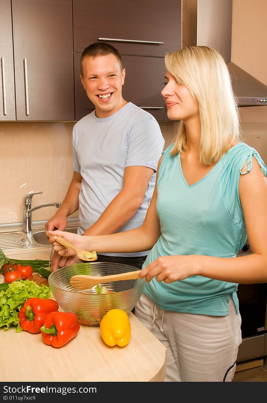 Couple making vegetable salad