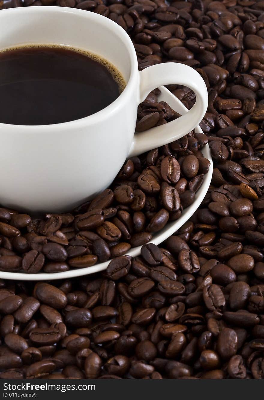 Coffee Cup On Coffee Beans Background