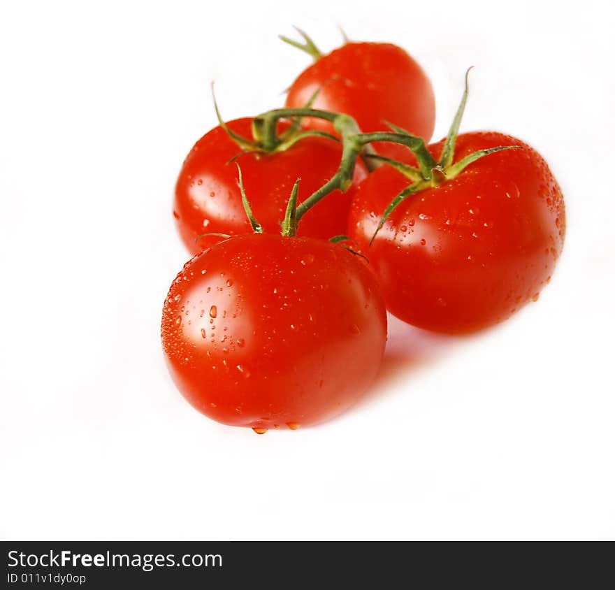 Cluster of red tomatoes isolated on white.