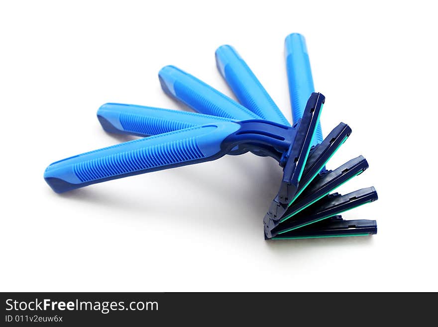 Many blue razor stacked together on white background. Many blue razor stacked together on white background.