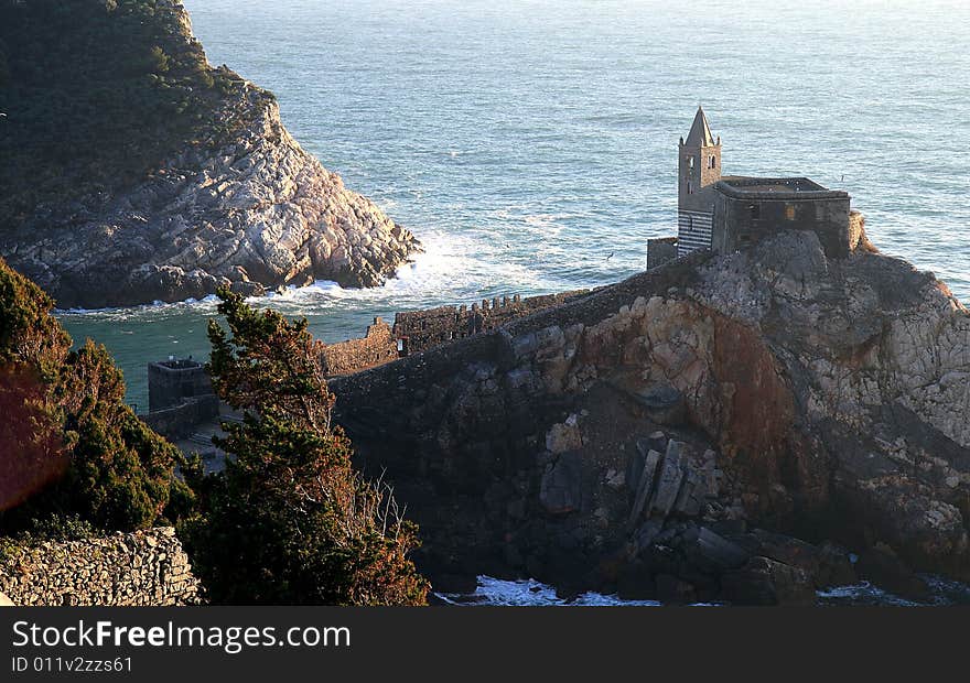 Fishing boats on a harbor with the seafront view of Portovenere in Italy.