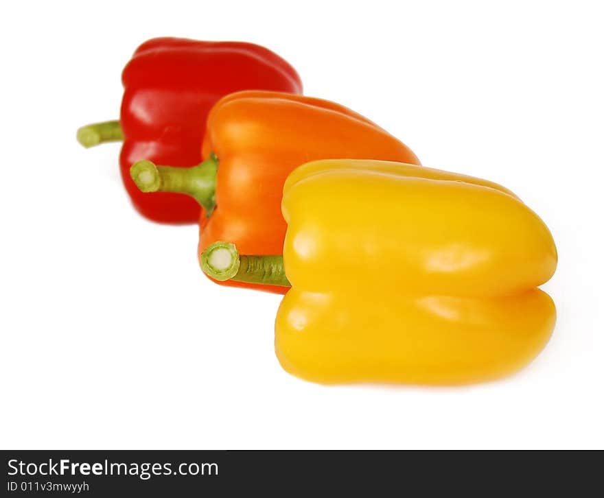 Red, yellow and orange pepper isolated on white