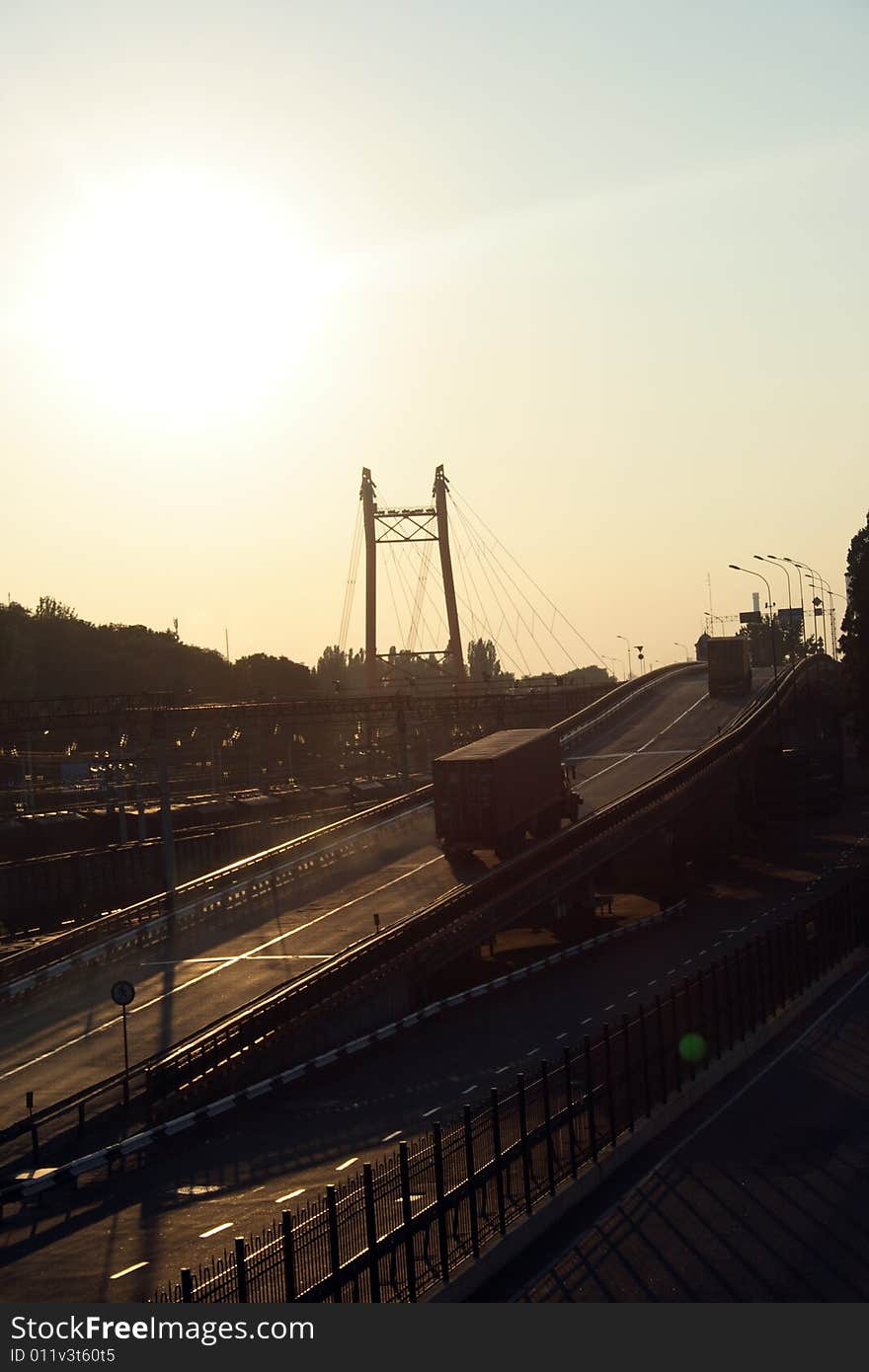 The bridge over the railway on the way to seaport of the city of Odessa, Ukraine, on a sunset