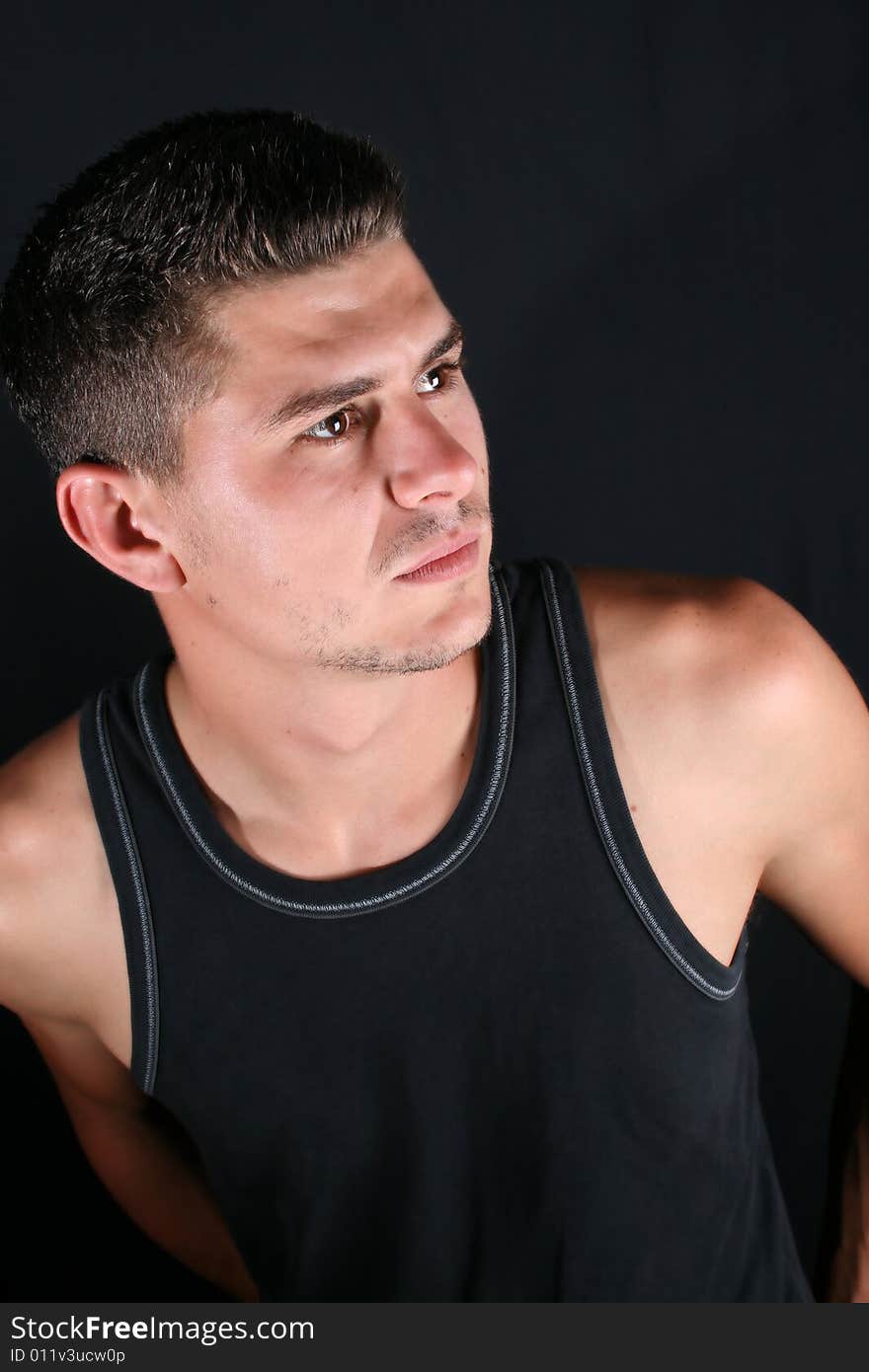 Male model in studio against black background