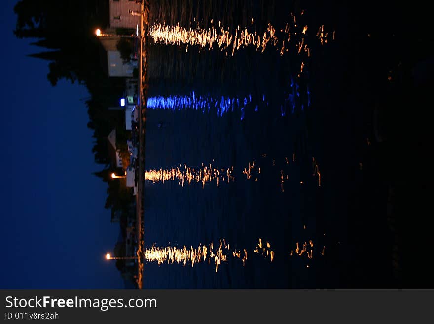 3 yellow lights and one blue leaving trace at water surface. 3 yellow lights and one blue leaving trace at water surface.