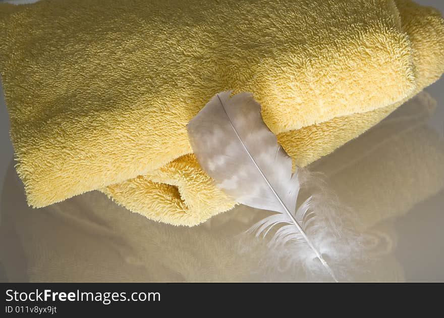 Two yellow towels with a feather. Two yellow towels with a feather.