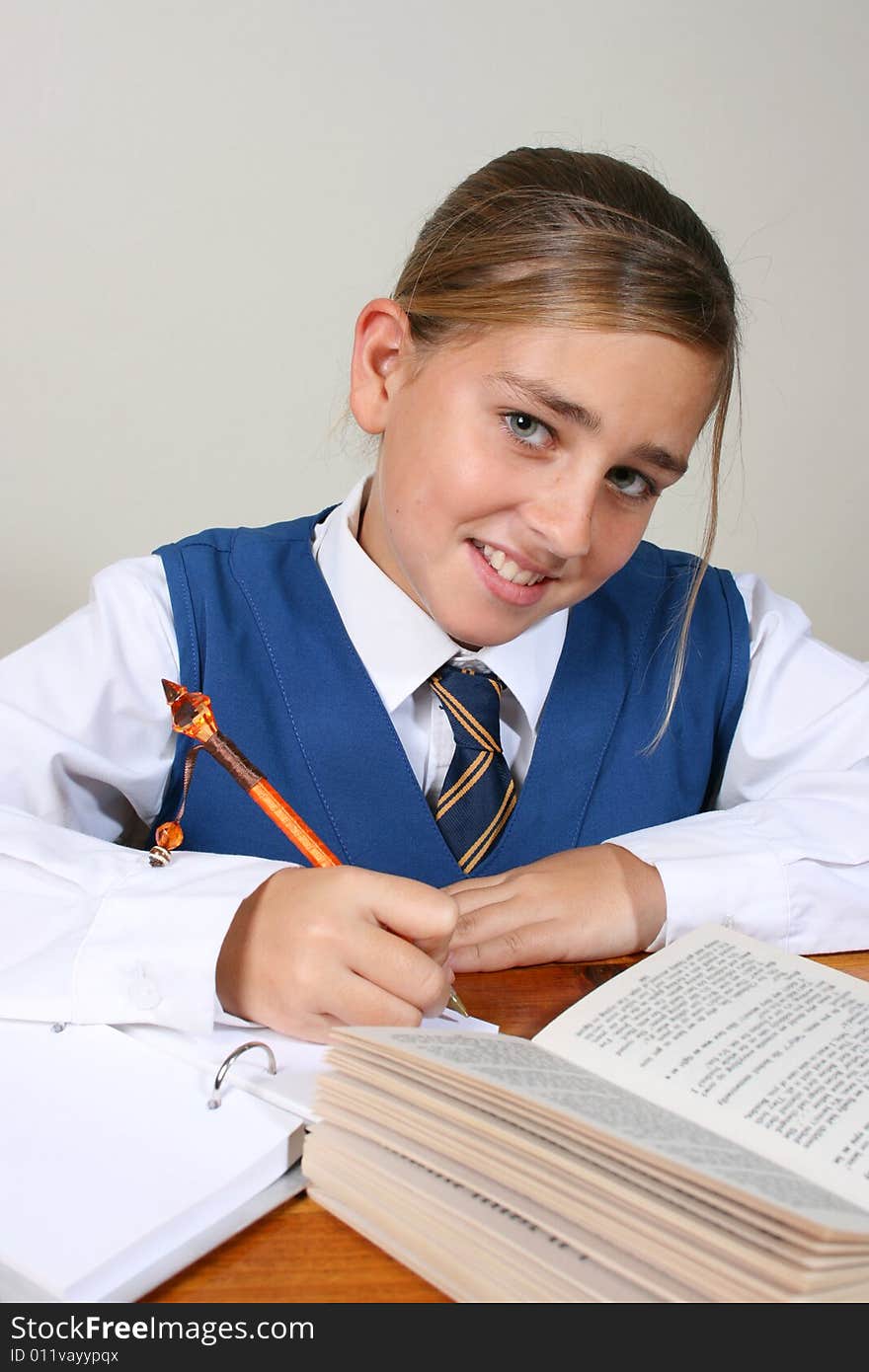 Teenage School girl busy with her homework, wearing uniform