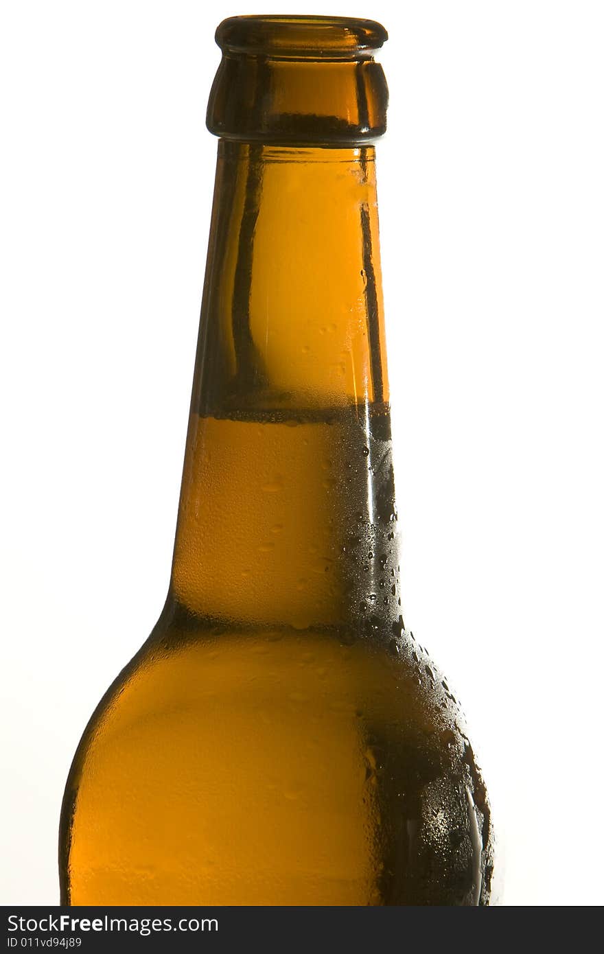 A brown beer bottle is filled with cool and fresh beer. A brown beer bottle is filled with cool and fresh beer.