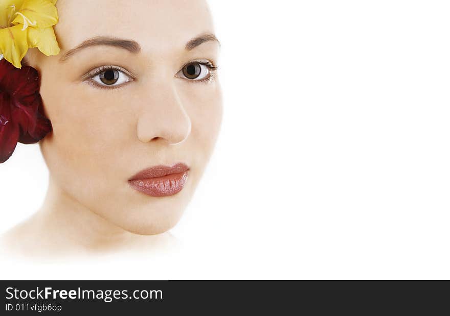 Woman with flower in hair and  red lips; white background. Woman with flower in hair and  red lips; white background