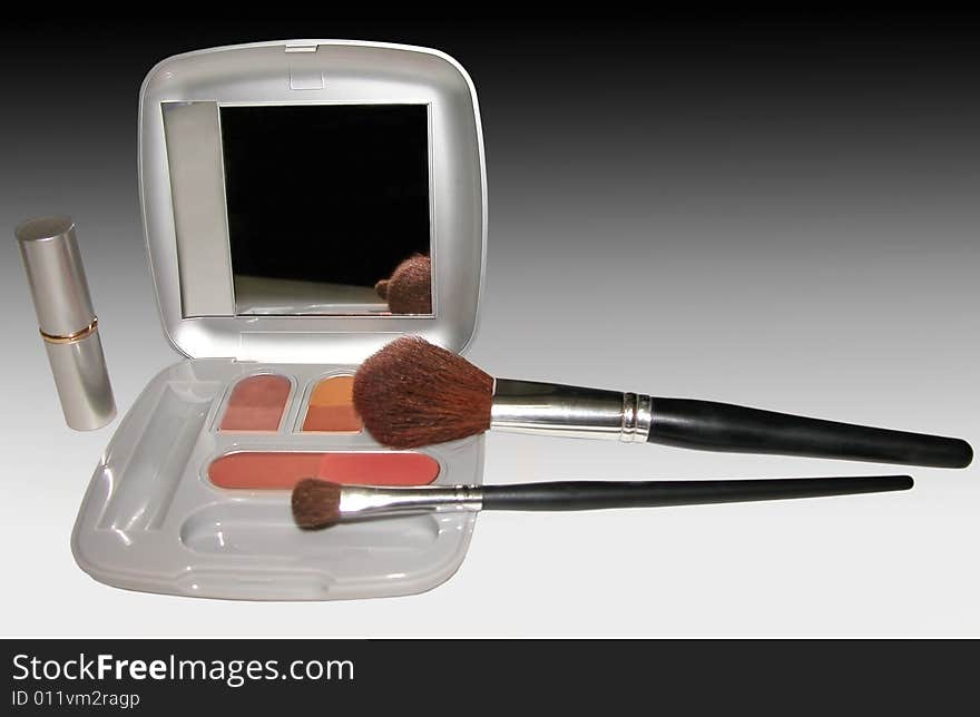 Set makeup with shadow, lipstick and brush