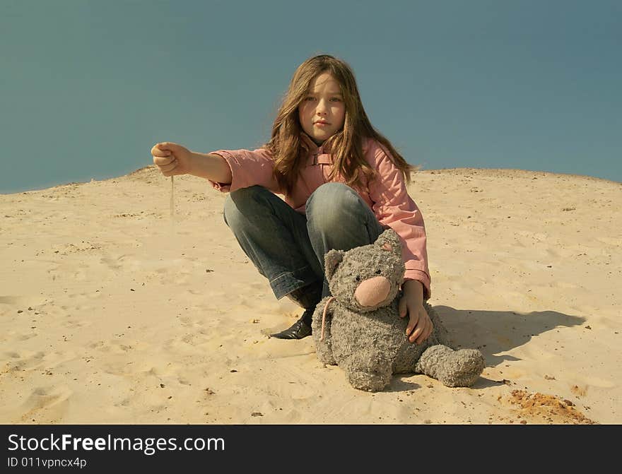 Sad girl with toy at sand. Sad girl with toy at sand