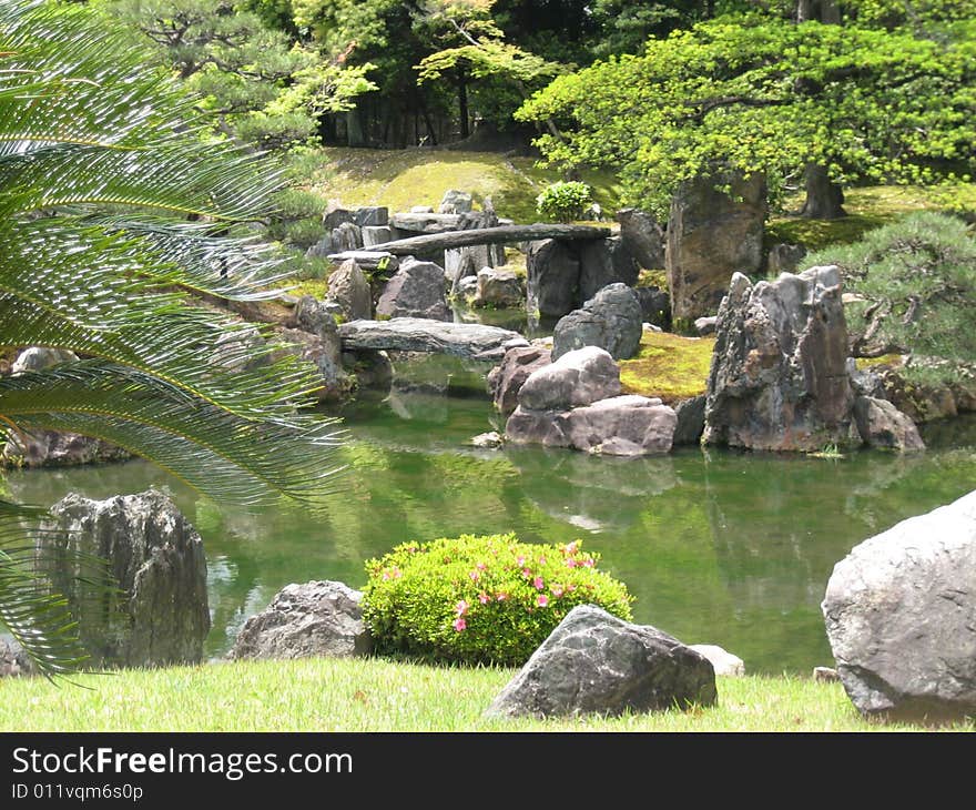 Pond surrounded by greenery and rocks, in a beautiful park Japanese. Pond surrounded by greenery and rocks, in a beautiful park Japanese