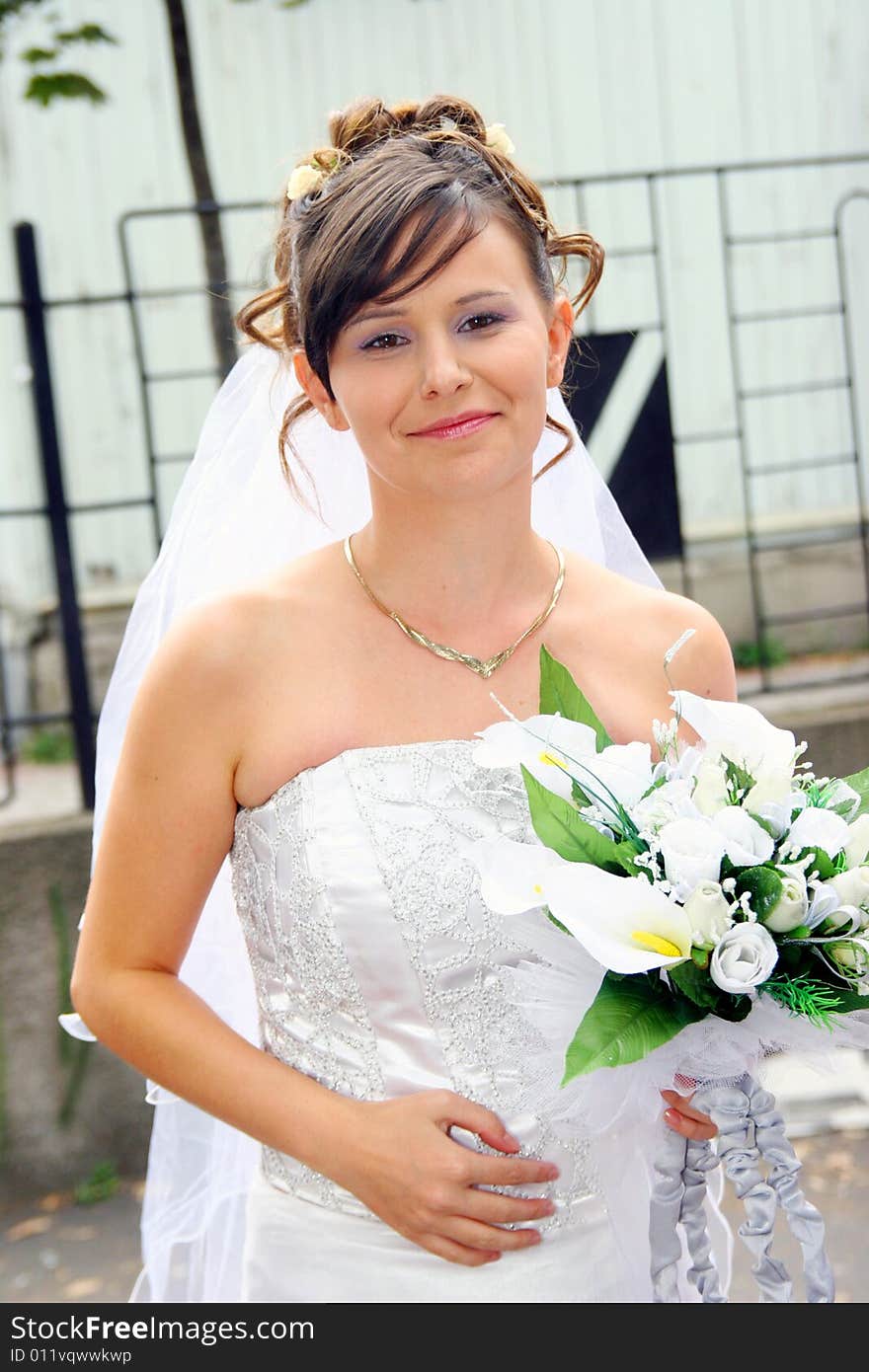 Beautiful happy bride standing outdoor. Beautiful happy bride standing outdoor