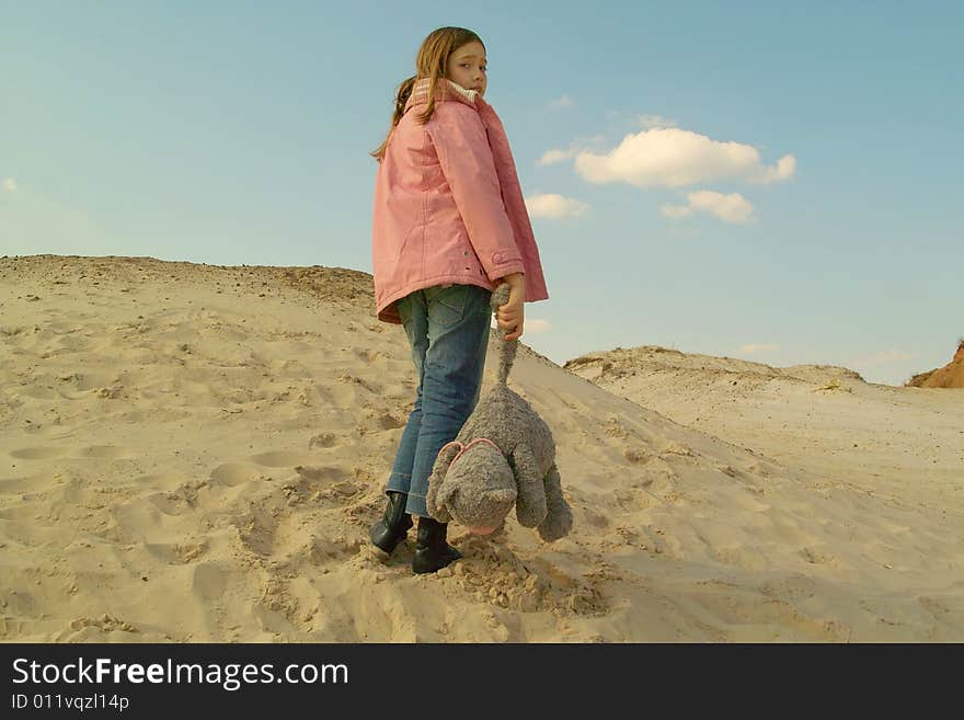 Girl with toy at sand