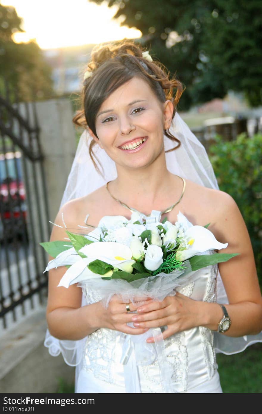 Beautiful happy bride standing outdoor. Beautiful happy bride standing outdoor