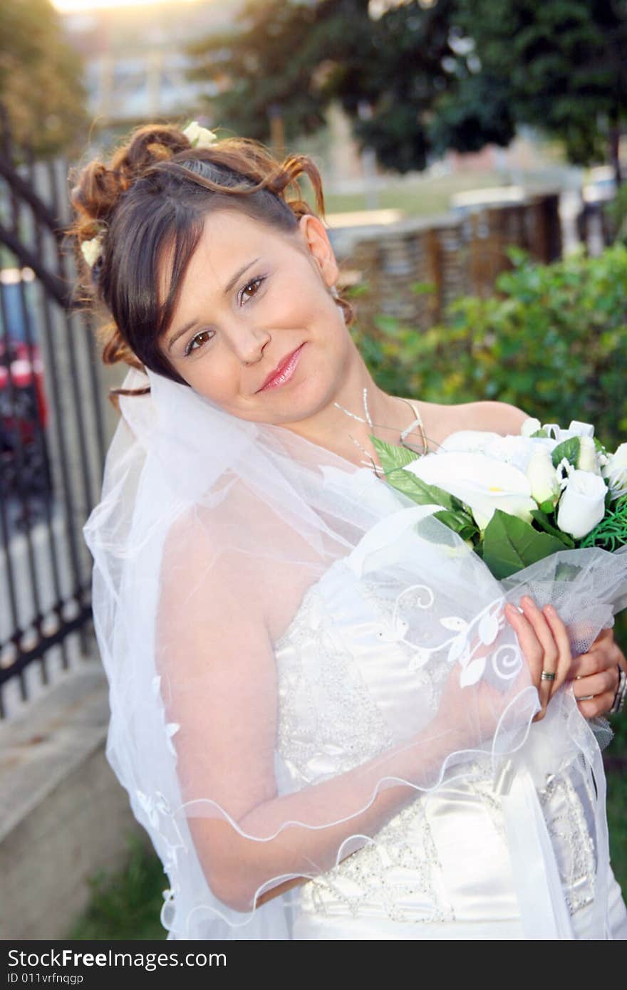 Beautiful happy bride standing outdoor. Beautiful happy bride standing outdoor