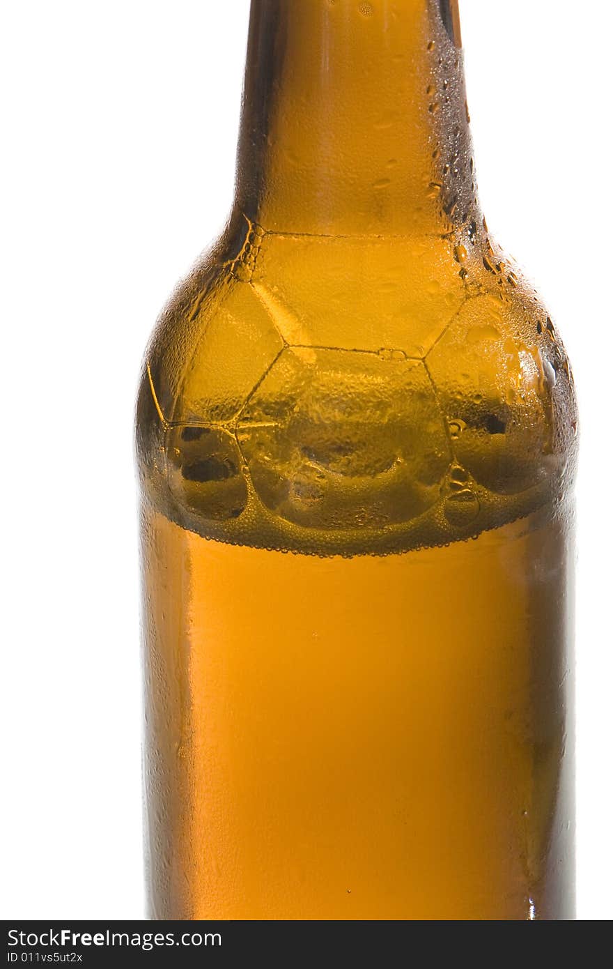 A brown beer bottle is filled with cool and fresh beer. A brown beer bottle is filled with cool and fresh beer.