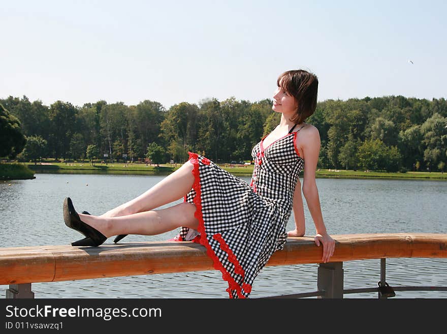 The girl sits on a bench and has a rest. The girl sits on a bench and has a rest