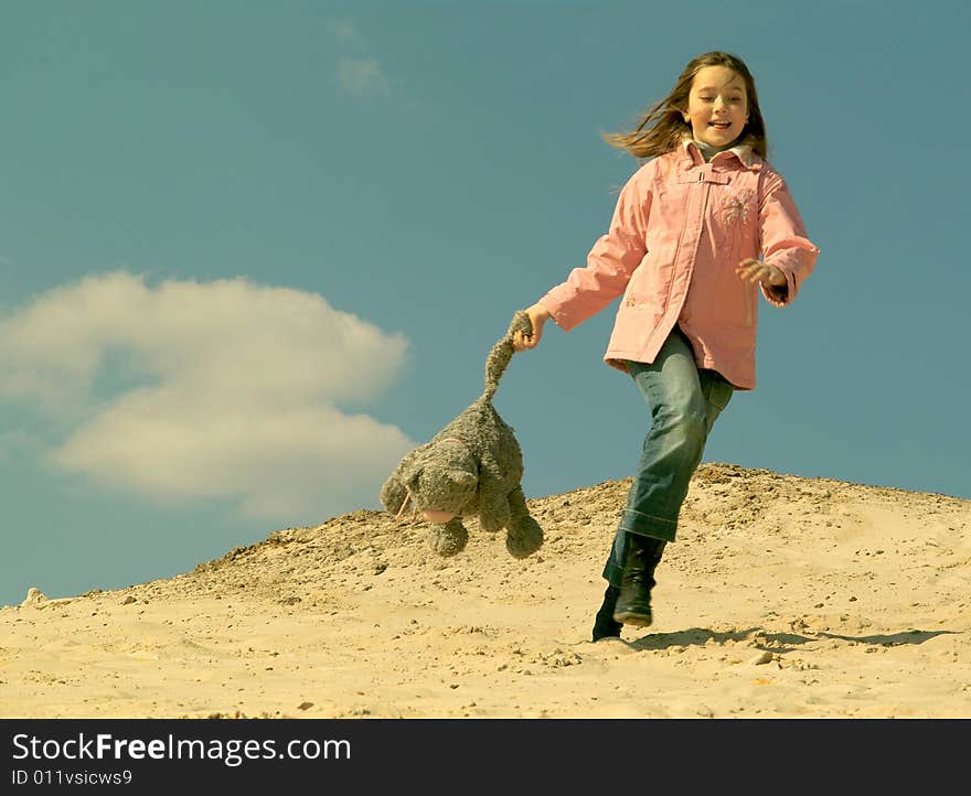 Louthing girl with toy at sand. Louthing girl with toy at sand