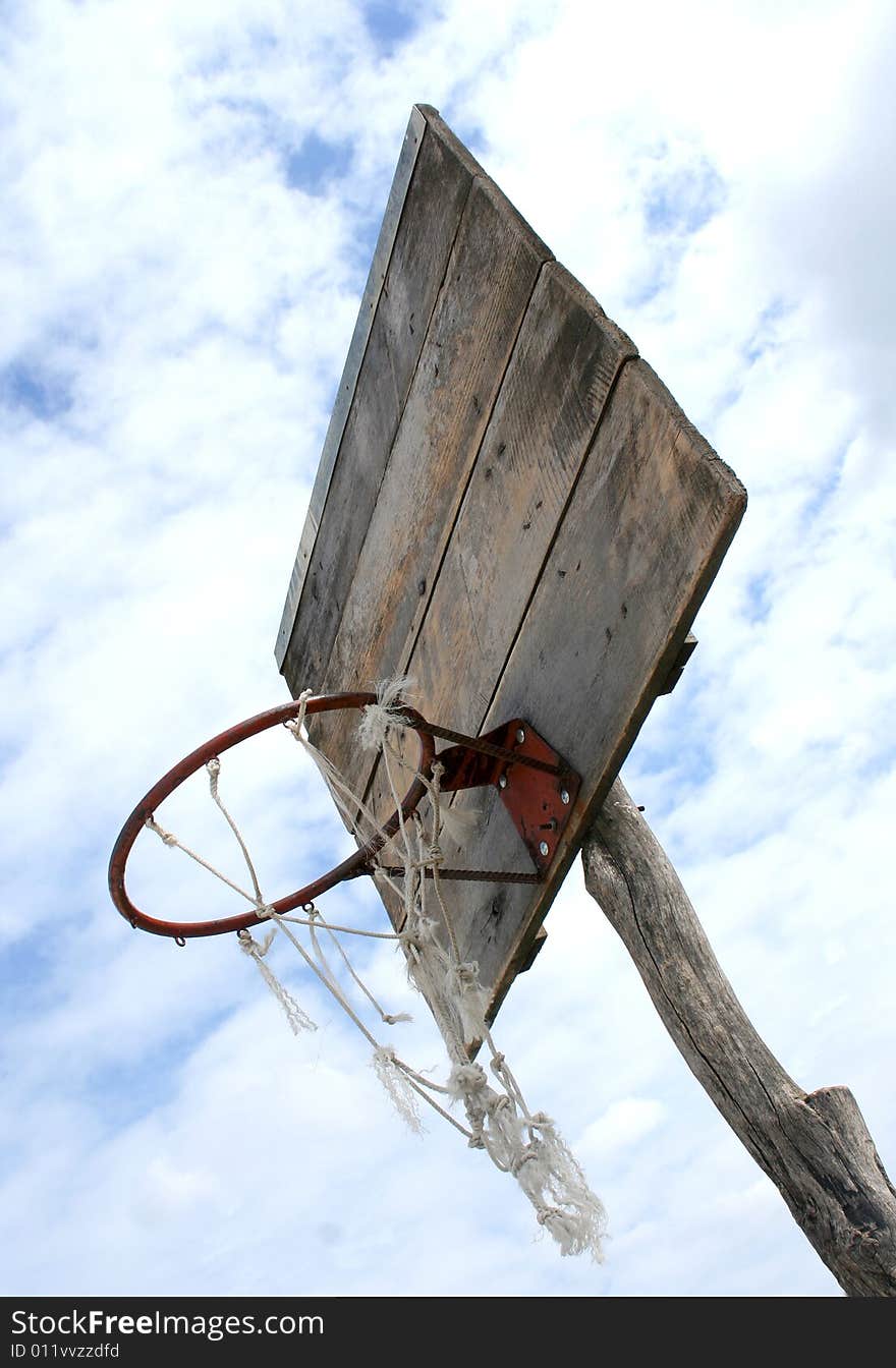 Low angle shoot of very old almost ancient basketball basket on the cloudy weather as background