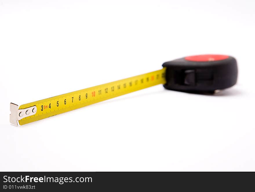 Measuring yellow tape tool over white background