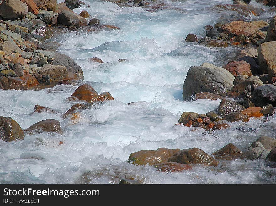 Water flowing over rocks in stream.