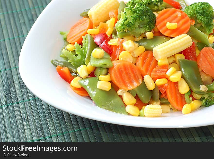 Cooked carrots sweet corn and broccoli on plate. Cooked carrots sweet corn and broccoli on plate