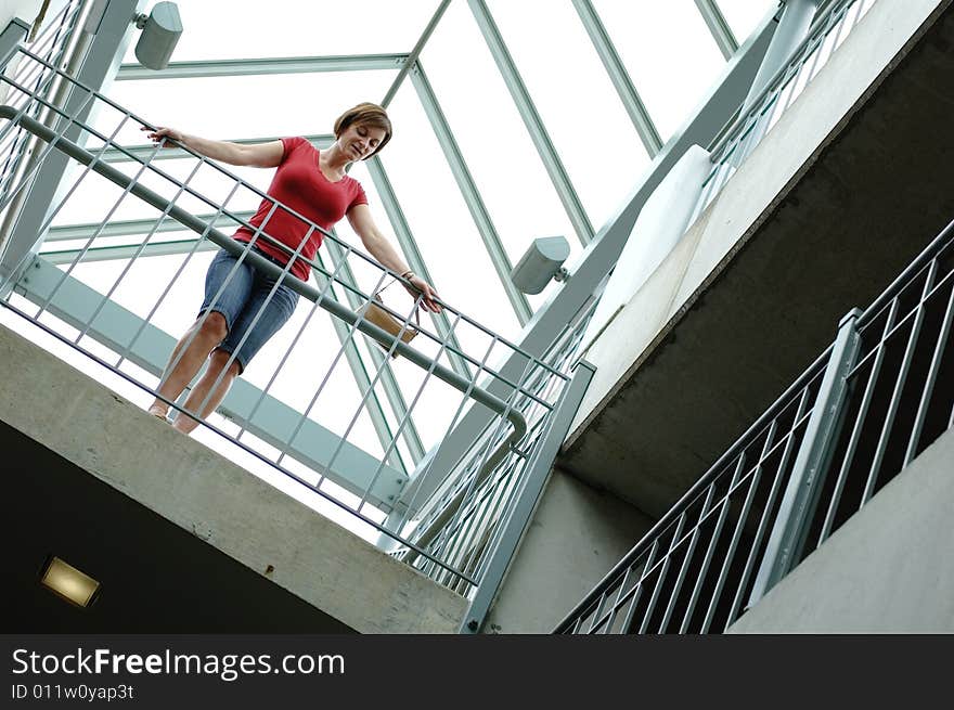 Woman standing on urban balcony looking around. Woman standing on urban balcony looking around.