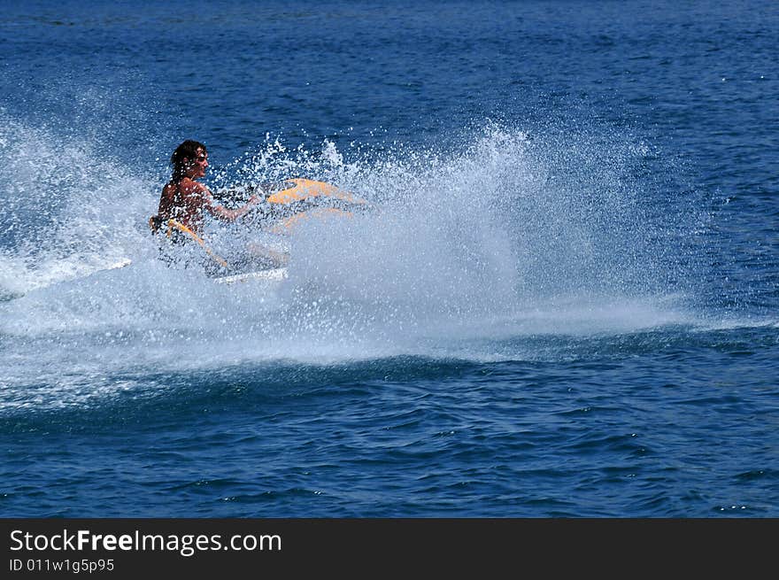 Boy on yellow jetski in the Adria near the island of Rab in Croatia. Boy on yellow jetski in the Adria near the island of Rab in Croatia