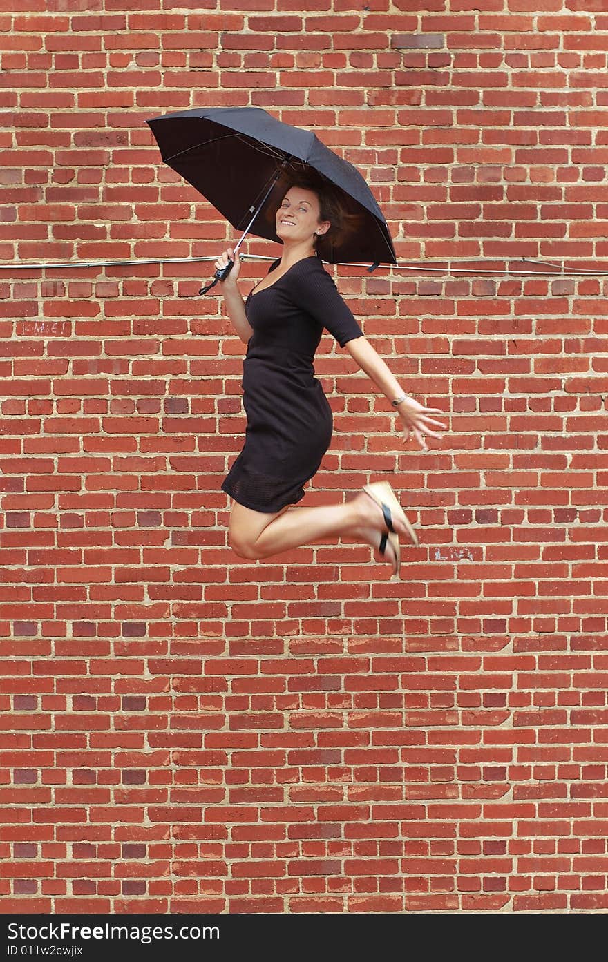 Lady jumping with umbrella high into air. Lady jumping with umbrella high into air.