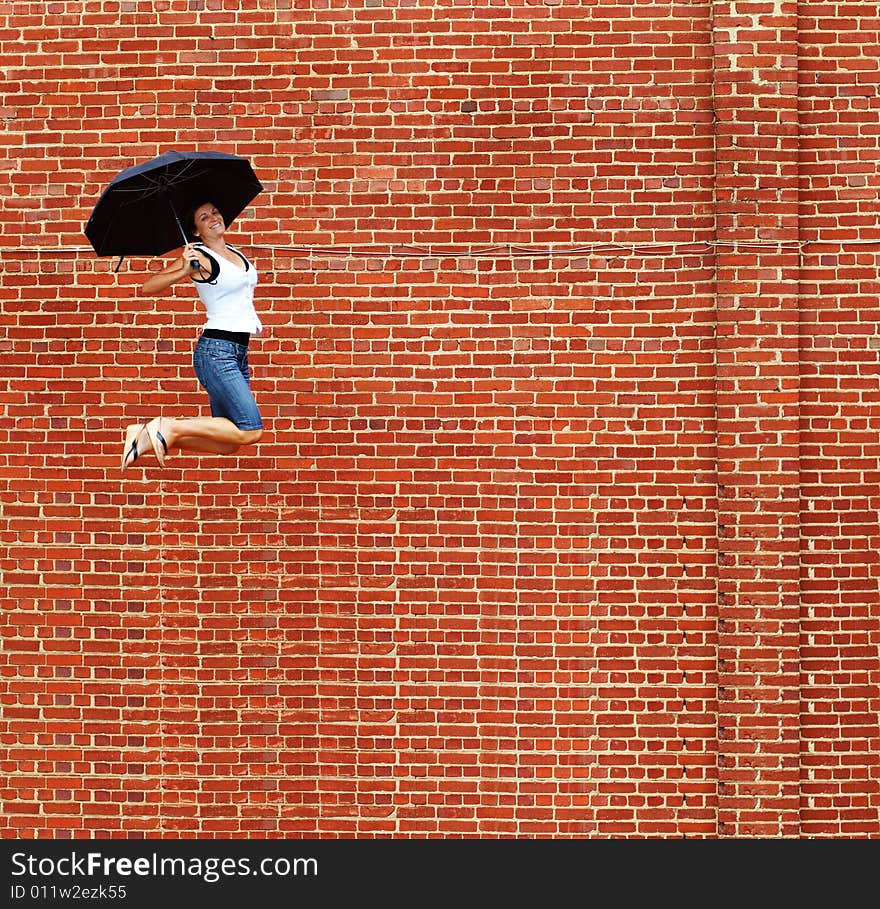 Lady jumping with umbrella high into air. Lady jumping with umbrella high into air.