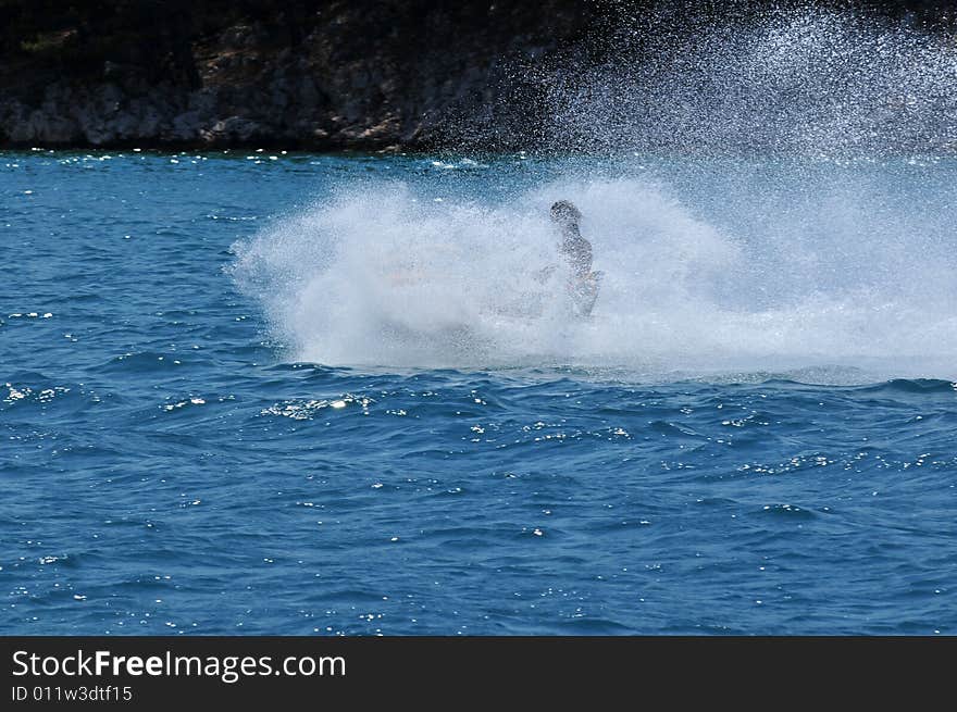 Boy on yellow jetski in the Adria near the island of Rab in Croatia. Boy on yellow jetski in the Adria near the island of Rab in Croatia