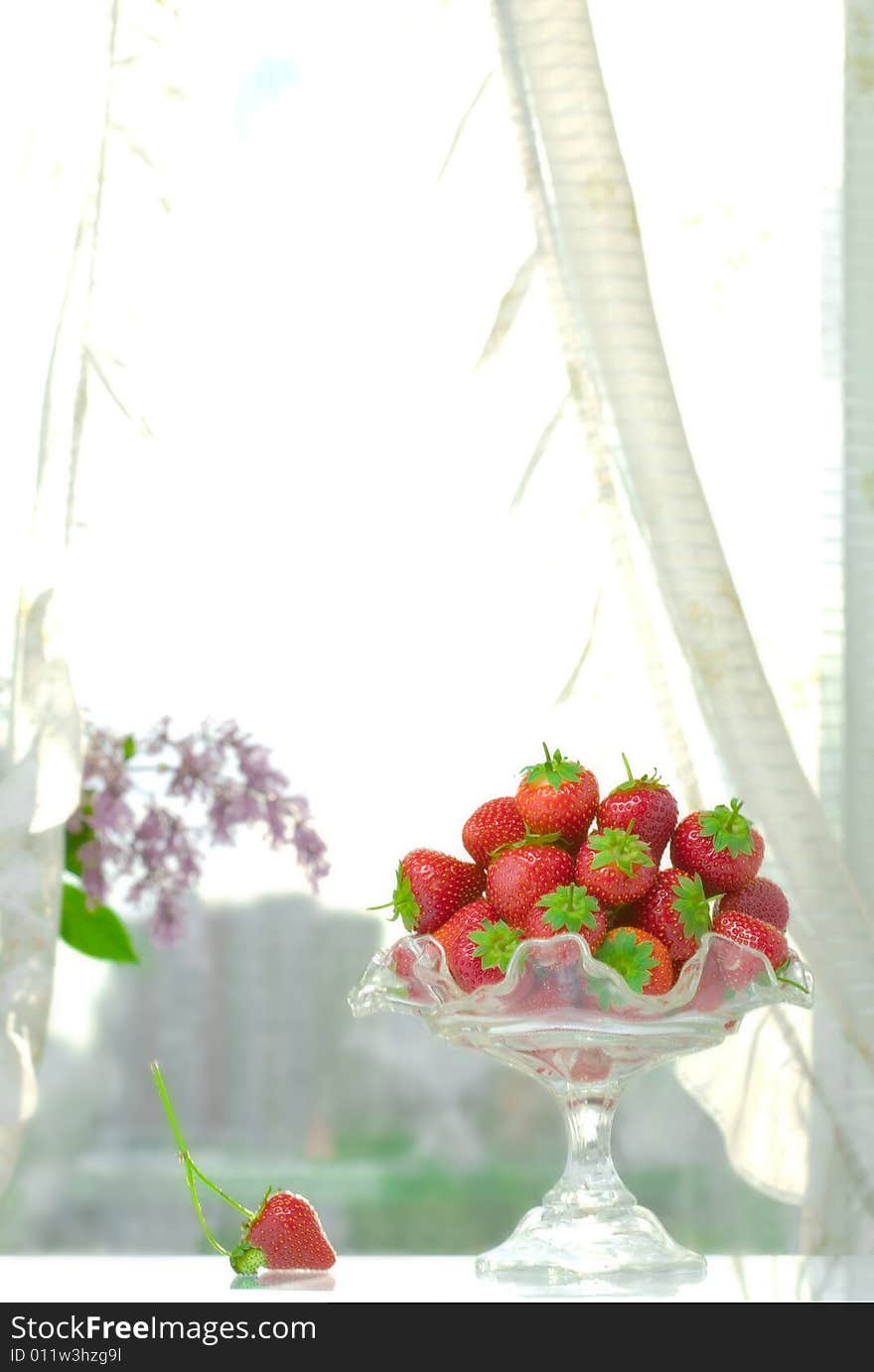 High key photo of fruit dish filled with nice red strawberries. High key photo of fruit dish filled with nice red strawberries