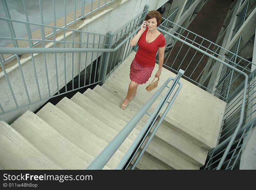 Urban woman walking up stairs.