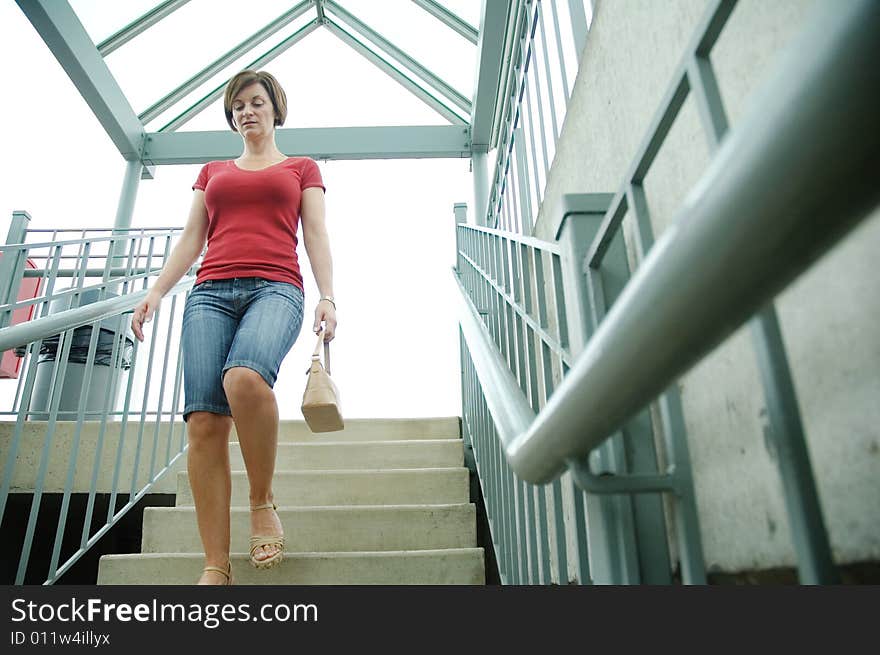 Urban woman walking up stairs.